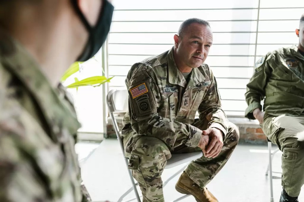 Soldiers sitting on folding chairs in a support group